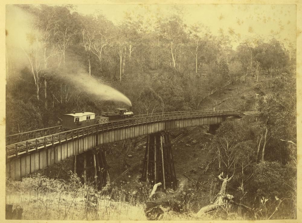 Locomotive coal wagon and carriage on the bridge in Main Range, ca.1880.