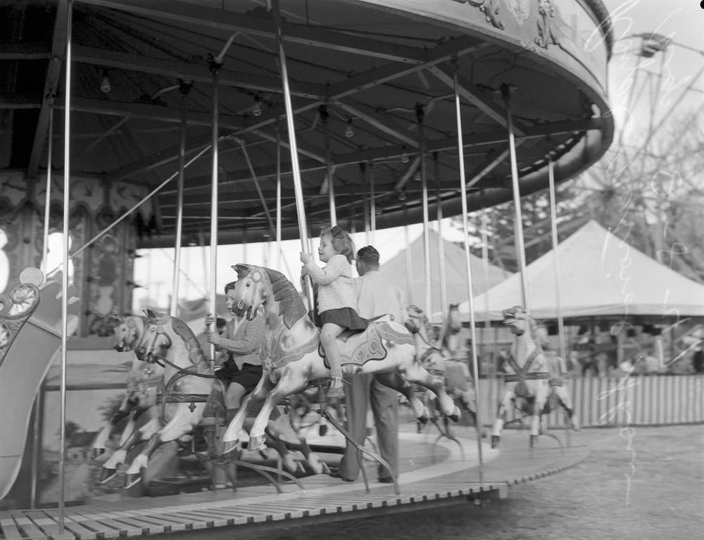 Children ride a carousel at the Brisbane Exhibition 1947 John Oxley Library State Library of Queensland Image 28118-0001-1383