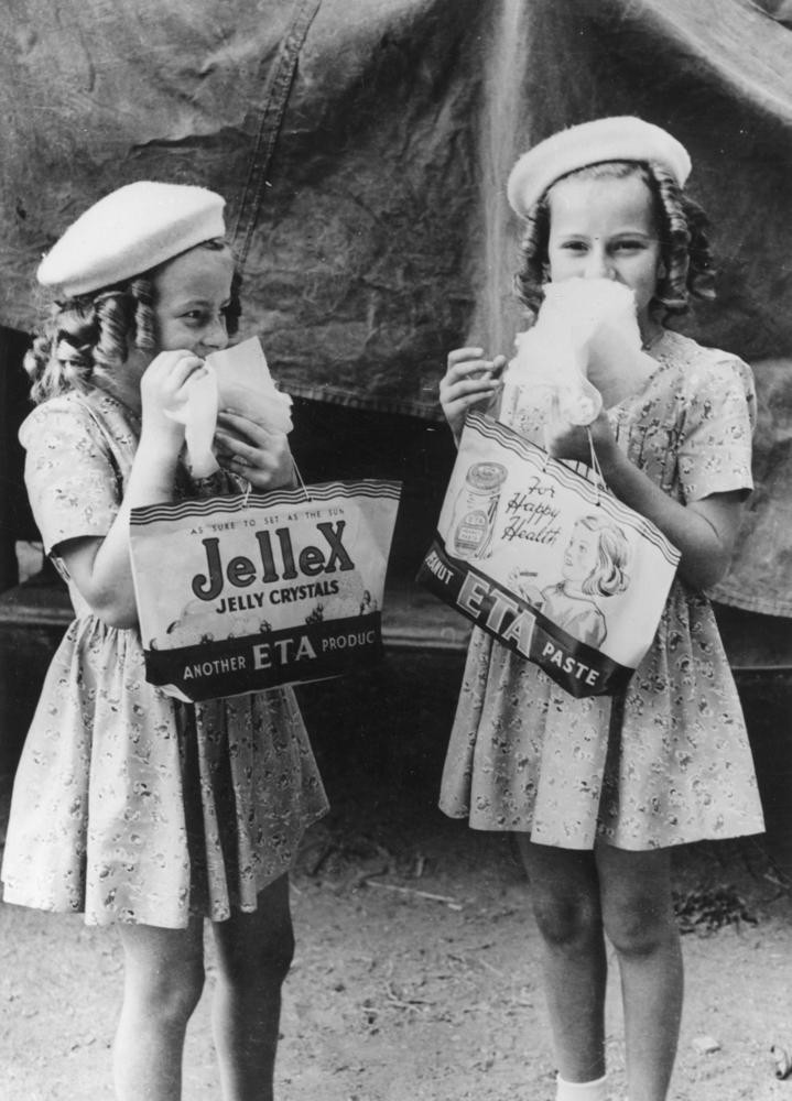 Two young girls enjoying themselves at the RNA Show, Brisbane 1946. John Oxley Library, State Library of Queensland. Neg 102785