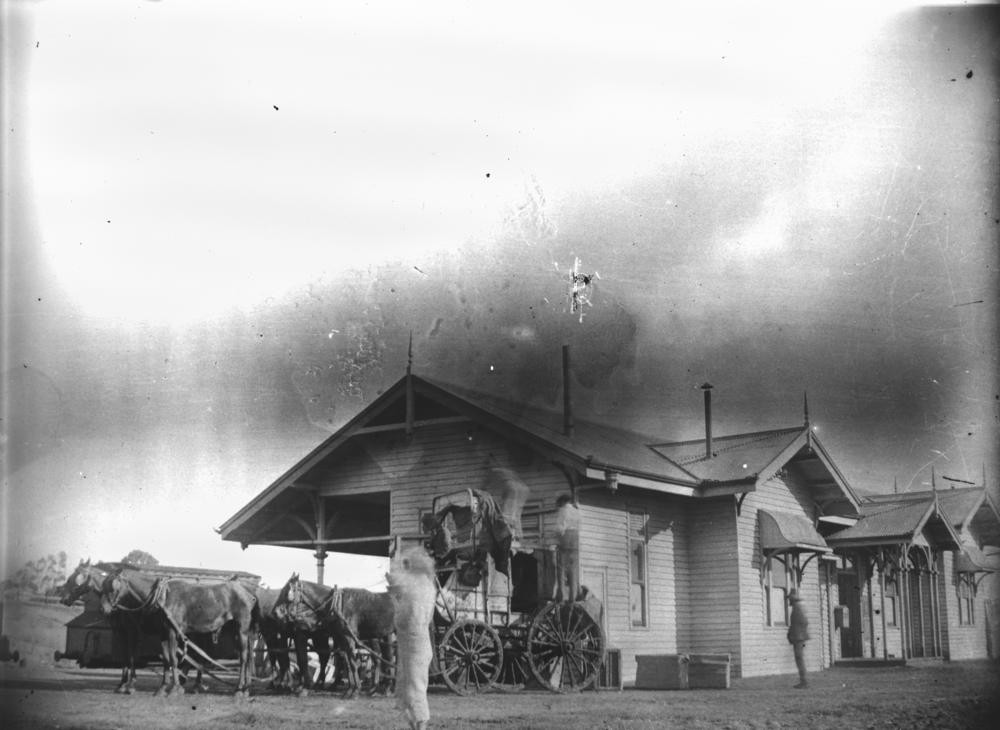 a horse drawn cart in front of a building 