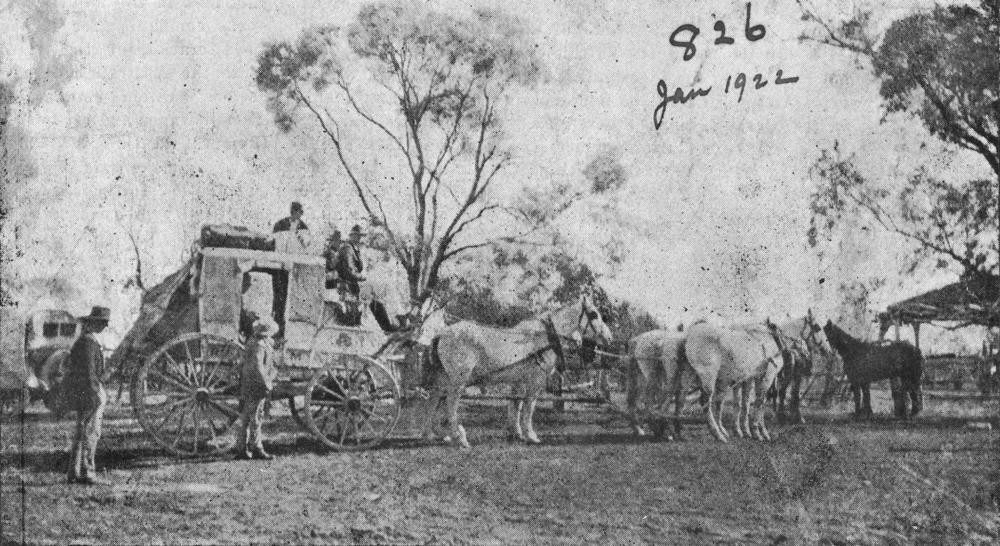 black and white image of people on a horse drawn cart infront of bushland 