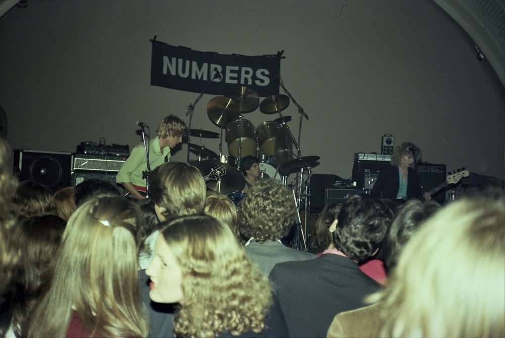 a crowd watches a band perform