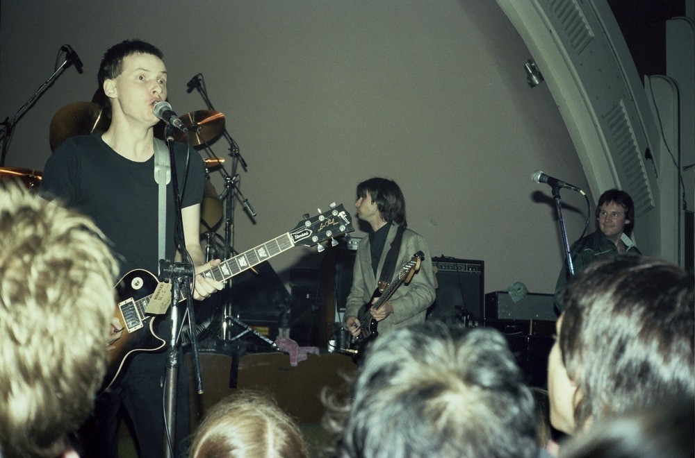 XTC band members perform in front of a crowd in Brisbane
