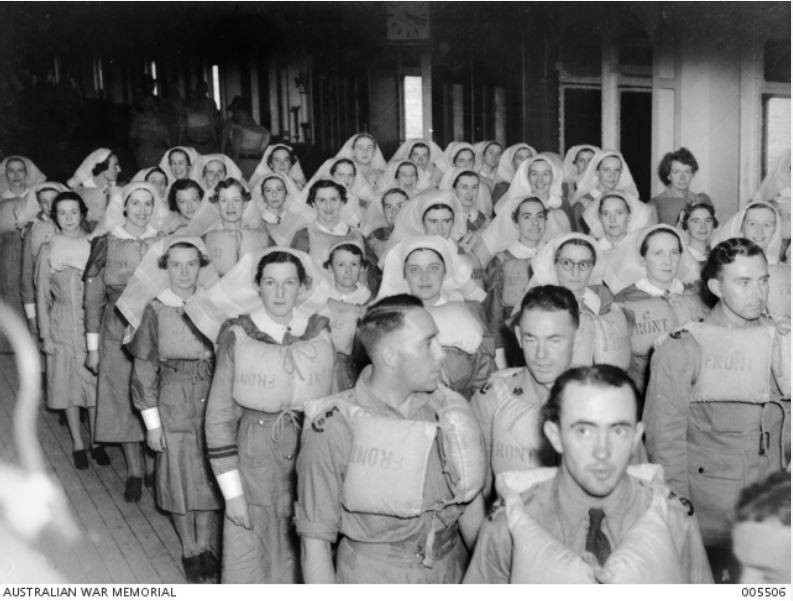 Soldiers and nurses standing during lifeboat drill