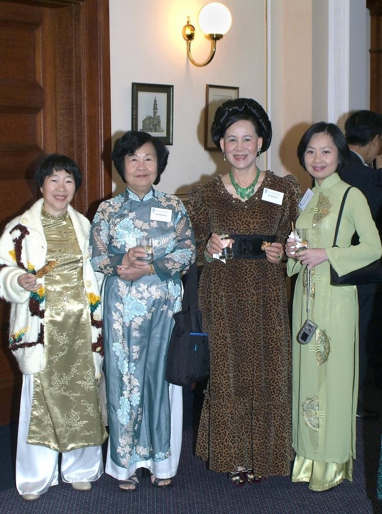 4 ladies dressed in traditional Vietnamese evening dresses