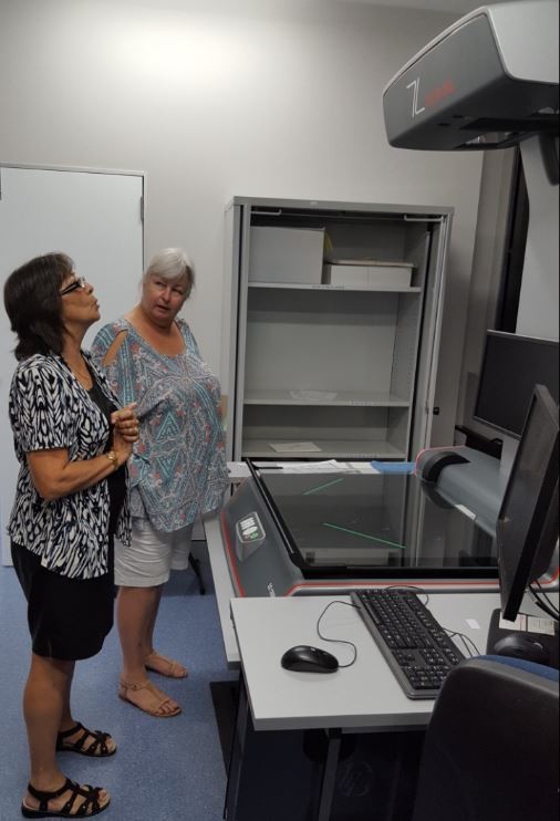 Helen from the Reformatting Unit explaining the Zeutschel scanner to Jeanette from Brisbane Bushwalkers Club