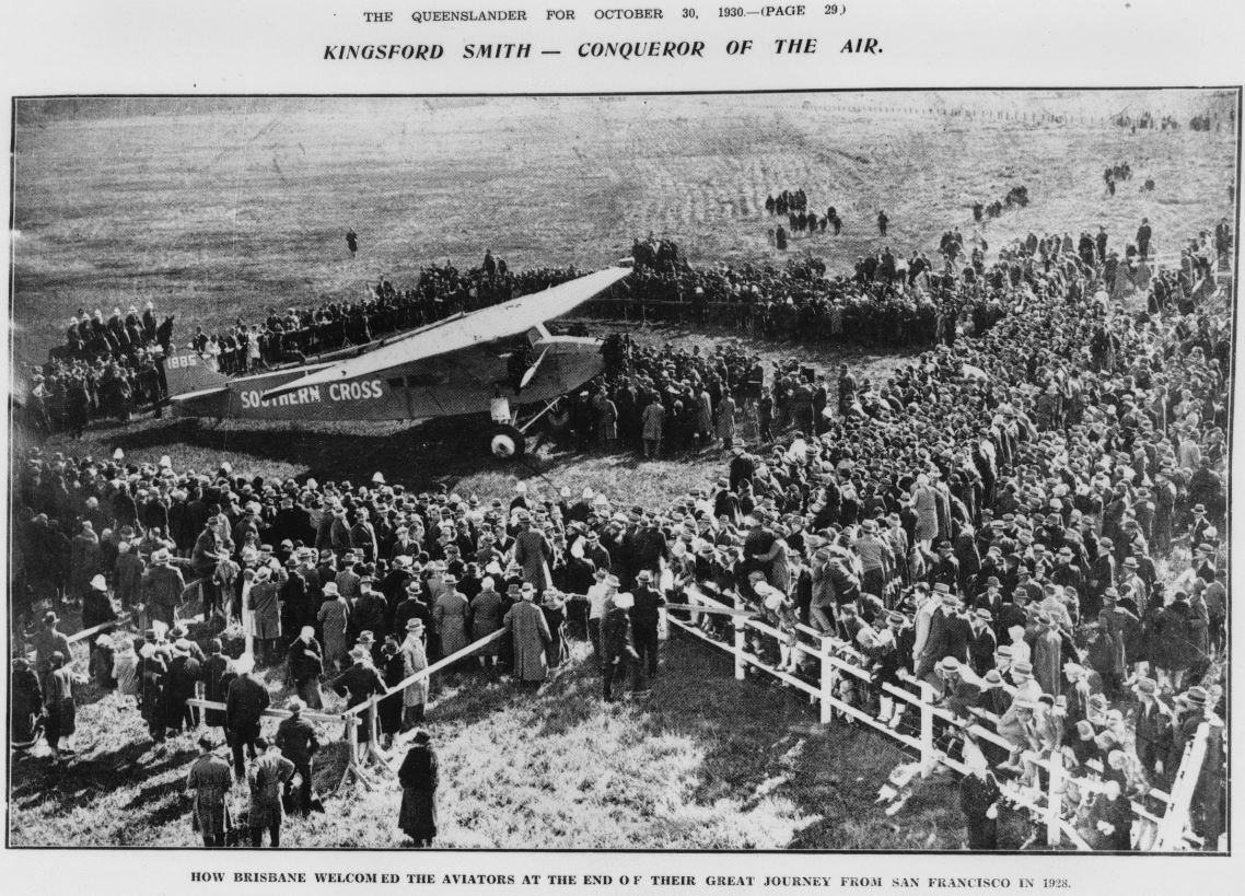 Kingsford Smith's Southern Cross in the centre of a huge crowd when he landed at Brisbane after flying from San Francisco. John Oxley Library, State Library of Queensland. Neg 61843