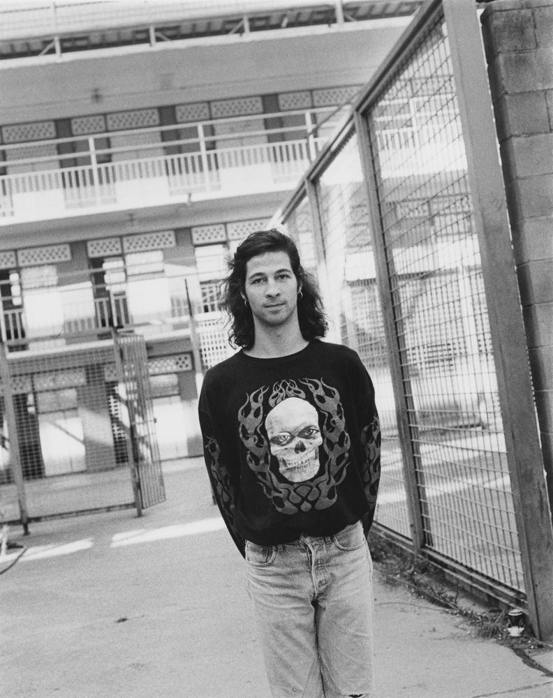 Photography by Kathy Dora. Simon Day from the band Ratcat at the Boggo Road Gaol for the Jailhouse Rock concert, Brisbane, 1993. In copyright. John Oxley Library, State Library of Queensland. Image 27175-0001-0004