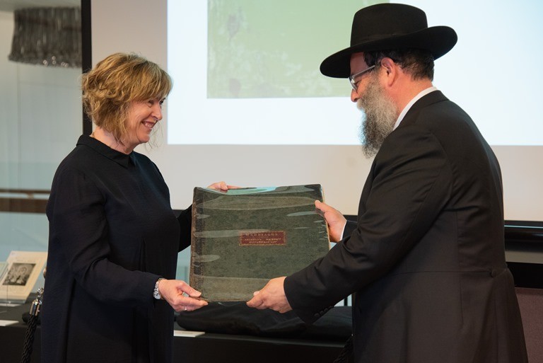 State Librarian, Vicki McDonald accepting the marriage register from Rabbi Jaffe, 16 April 2019