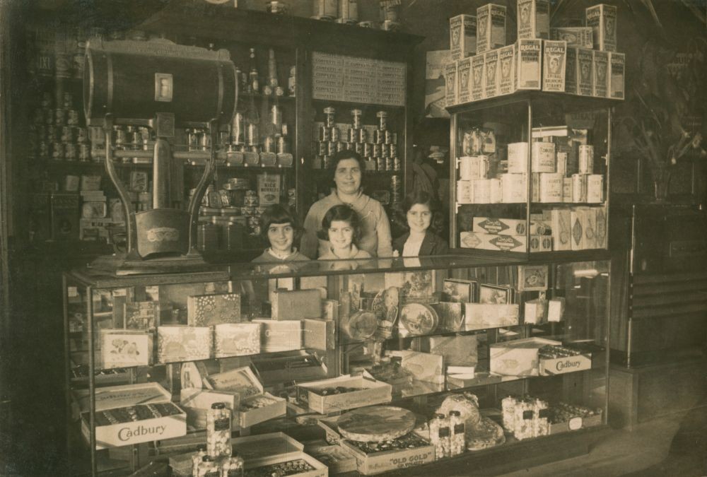 Irene Andronicus with her children, Katie, Ada and Mary, behind Cafe Mimosa Counter, Maryborough, 1930.