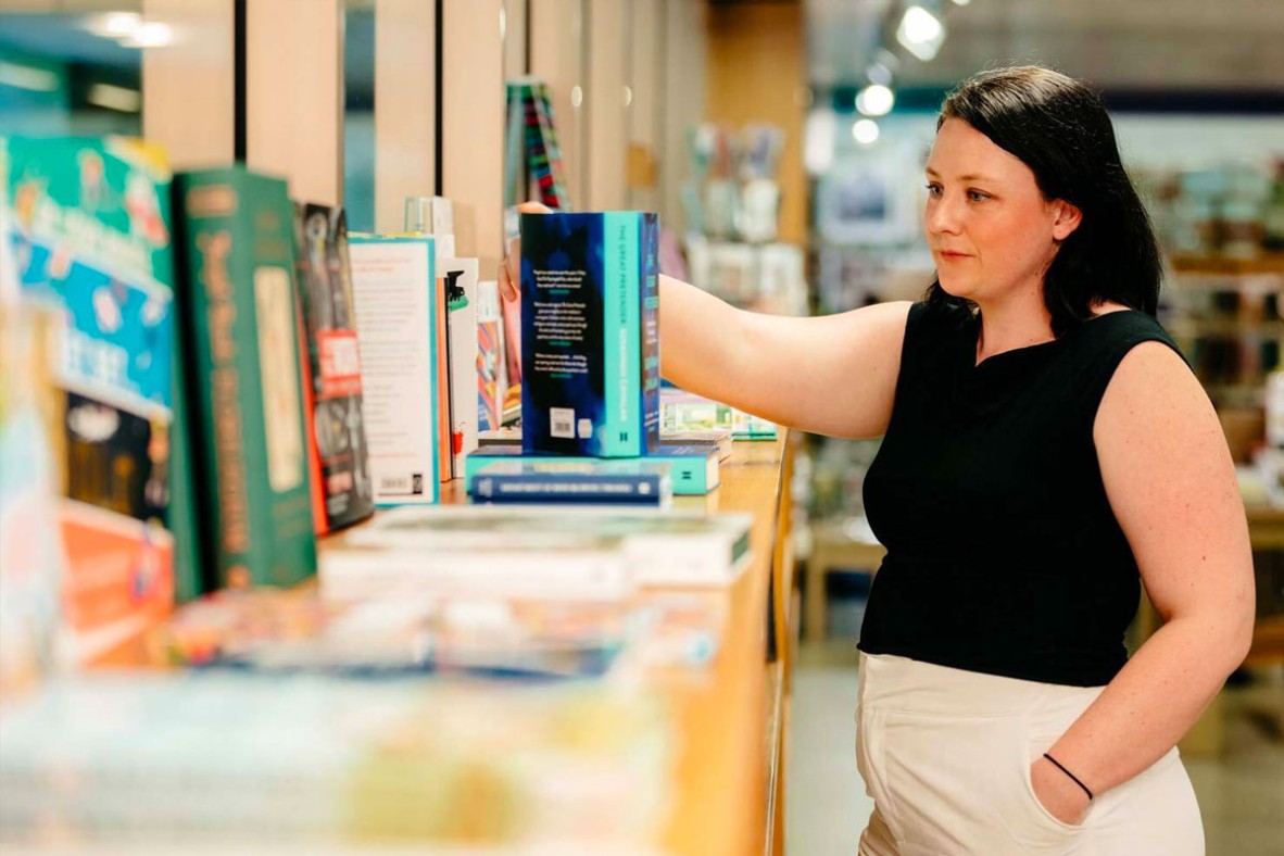 Woman browsing books at the Library Shop