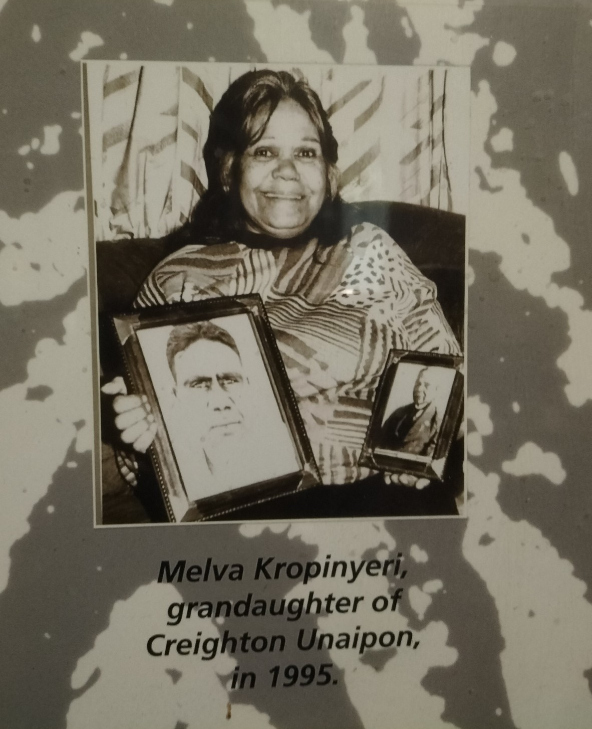 Aunty Elaine Kropinyeri's mother Melva is smiling and holding photographs of family members