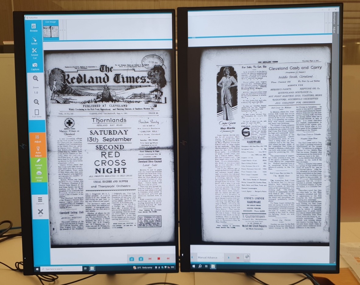 A microfilmed newspaper showing on two computer screens