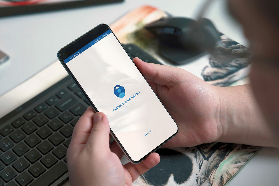 Person using a phone with the Microsoft Authenticator app.