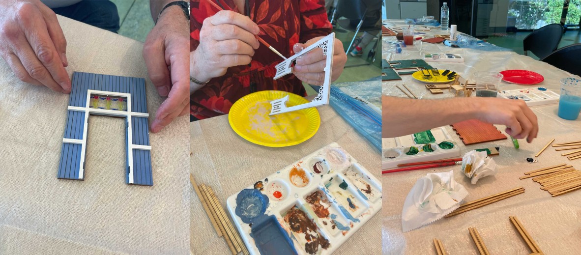 Three different QLD Mini participants painting their book nooks. One is painting the front and showing off the stained glass, the 2nd is painting a archway design and the other is painting the walls.