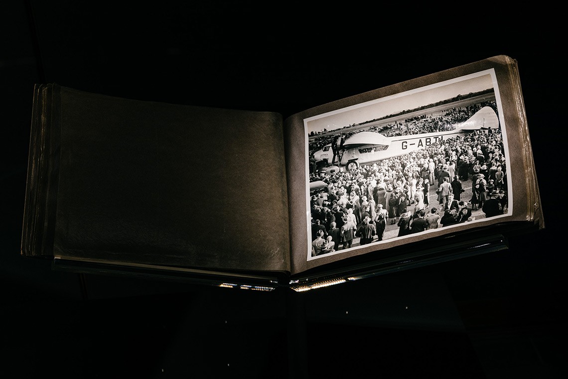  Black and white photograph of the aeroplane "Astraea' which visited Brisbane in June 1933.  The image shows a side view of the aeroplane surrounded by a throng of men, women and children who had gathered to witness the event.