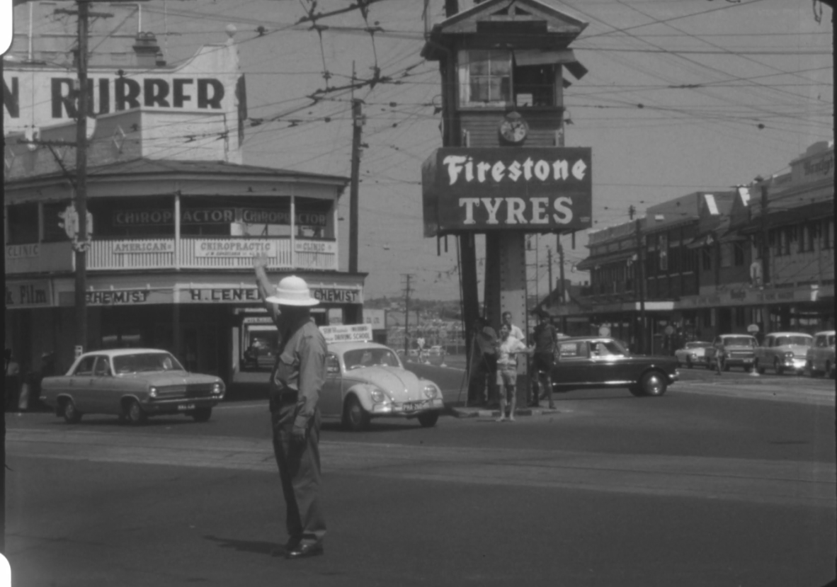 Traffic policeman, Woolloongabba Fiveways. Still from 29226 Bill Rahmann films (Film 26).
