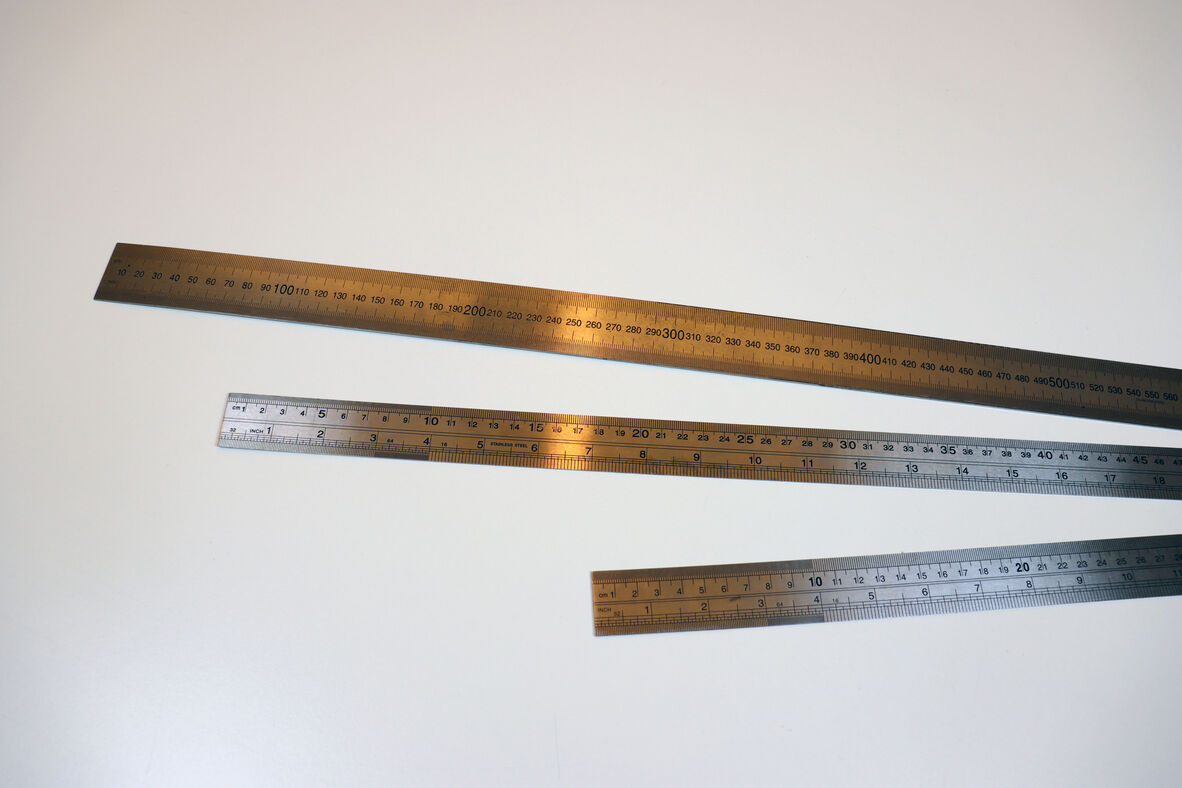 A photo of three sliver measuring rulers.