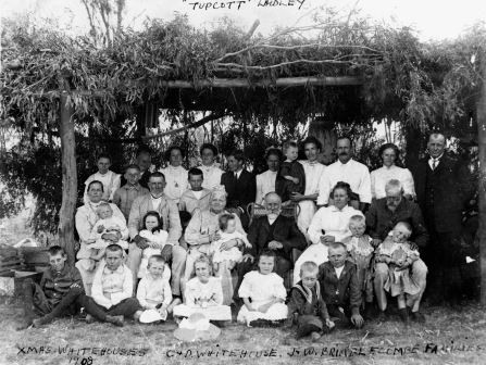 Family portrait of two families taken outdoors, 1908.