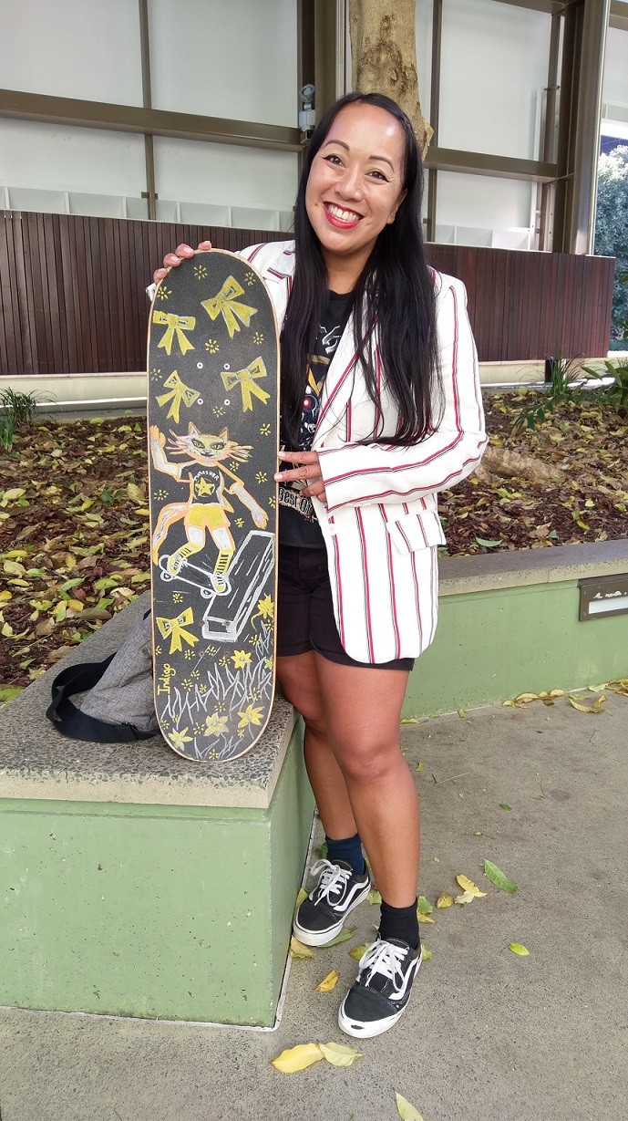 Indigo with her skateboard outside State Library of Queensland.