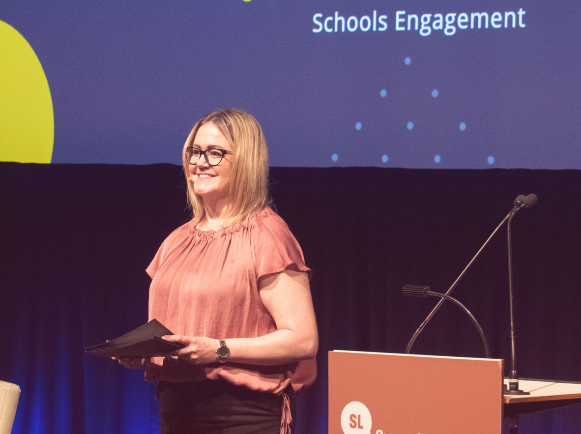 Natasha Ratajczek speaking at the podium