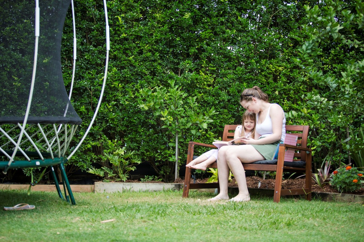 Mother and child reading in the garden