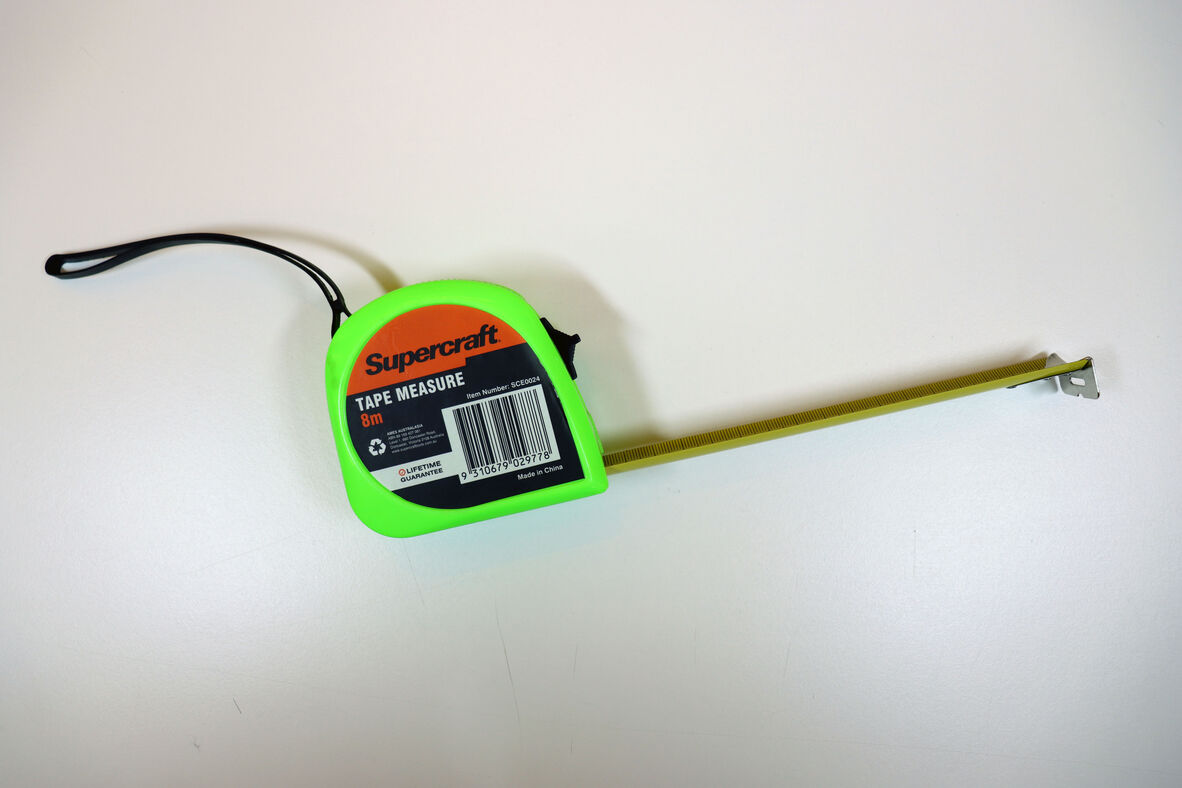 A photo of a bright coloured Tape measure.
