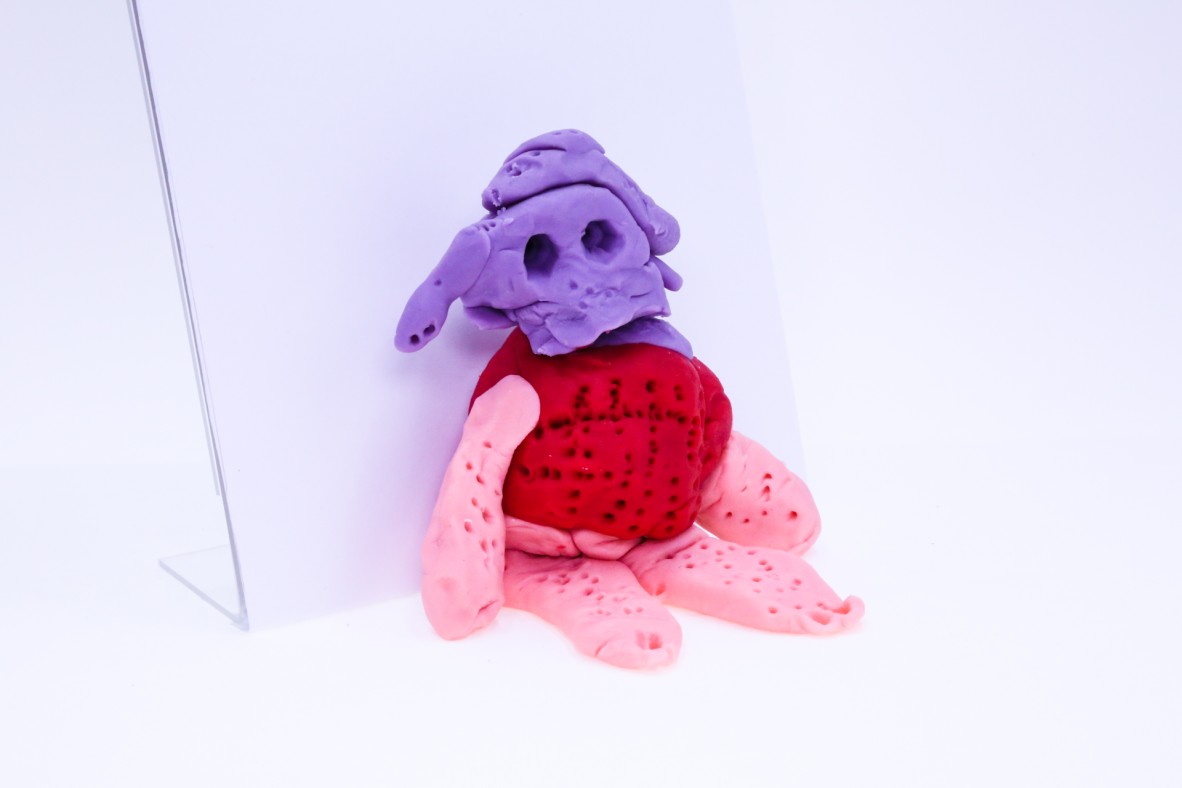 The thingy mijig is a red pink and purple play-dough sculpture