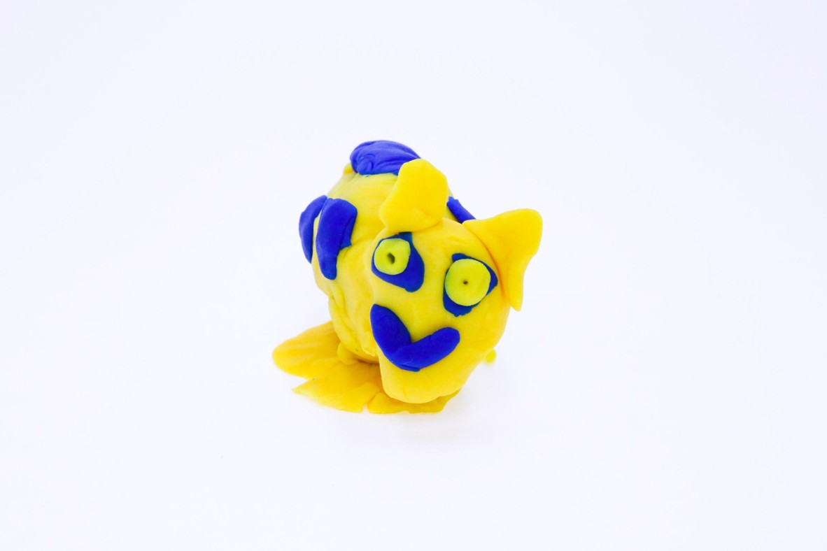 Chris Jnr is a yellow and blue play-dough sculpture that breathes fire and has bone crushing teeth