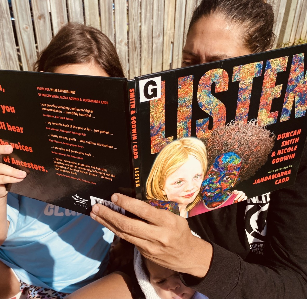 Adult and child reading Listen