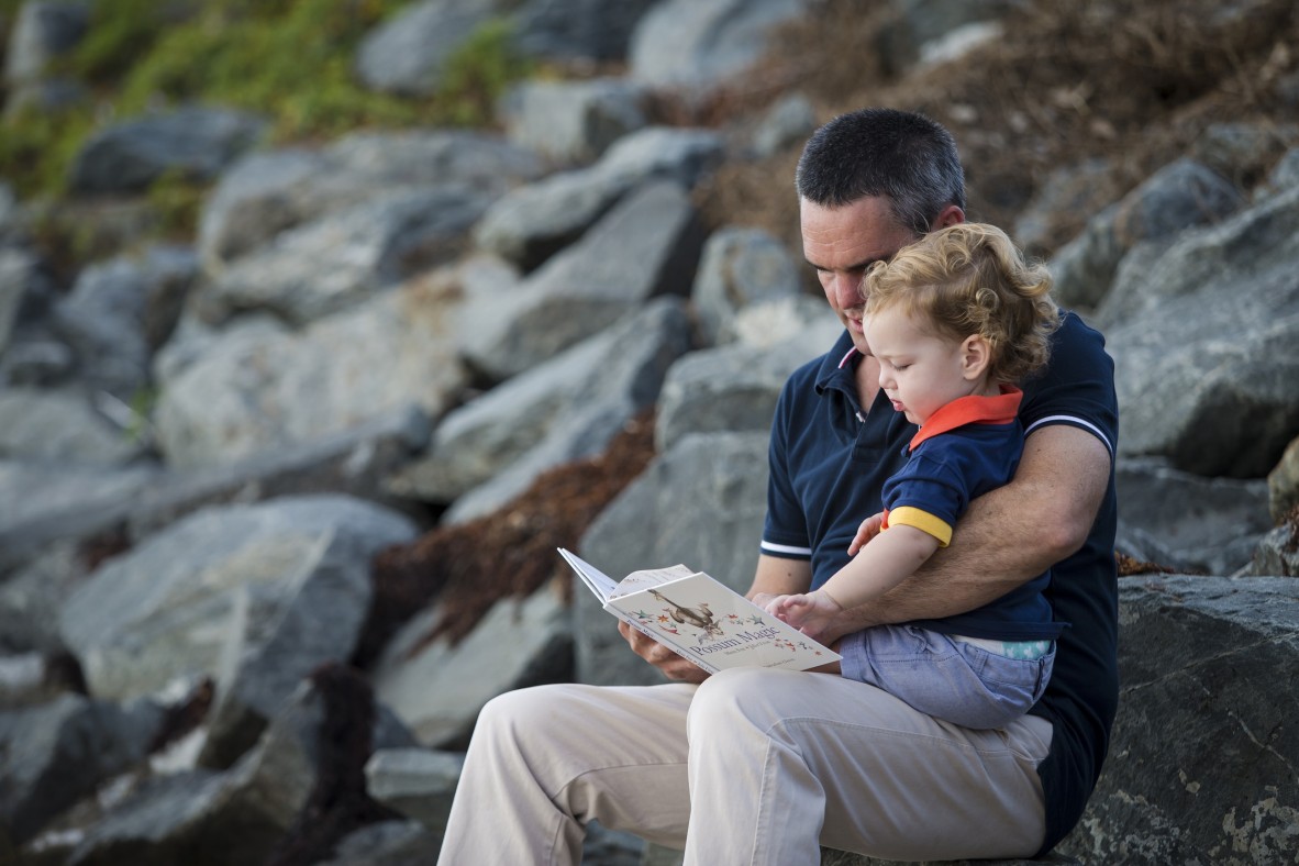 Toddler and father reading a book