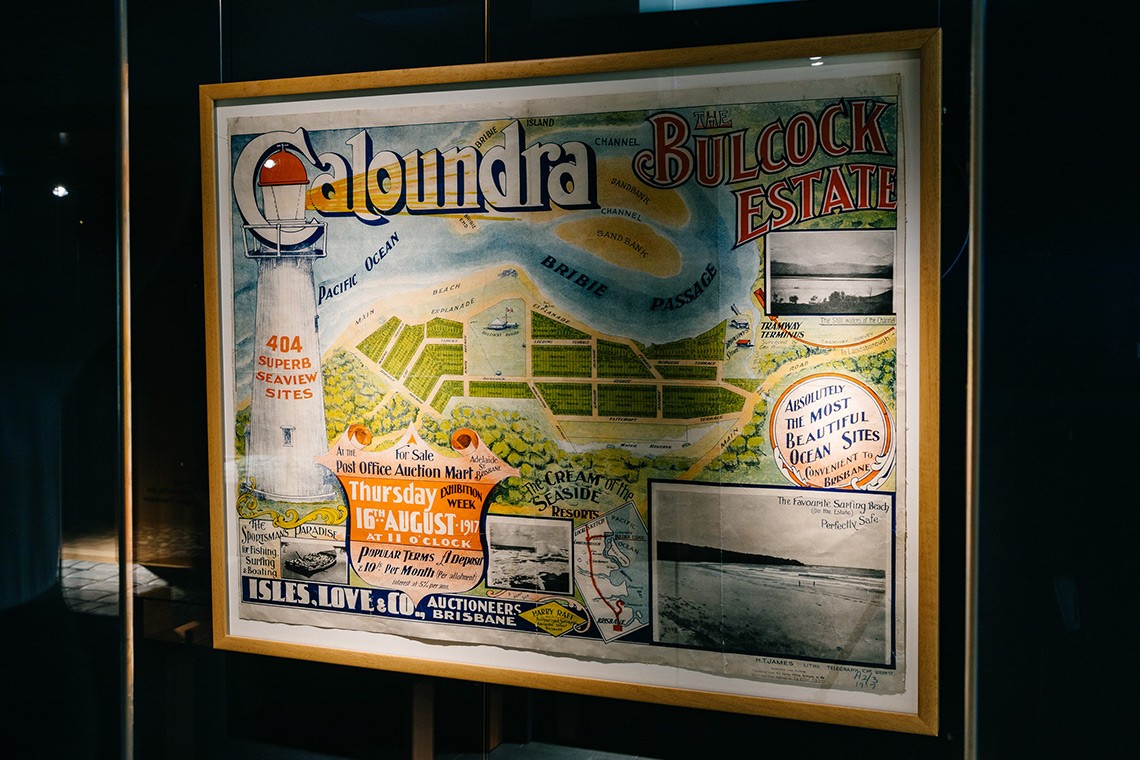 1917 real estate map advertising land for sale at the Bulcock Estate in Caloundra. The coloured map  features an illustration of a lighthouse and four black and white photographs of the locality.  The central feature is an illustrated map of the Caloundra Explanade and the waters of the Bribie Passage. 