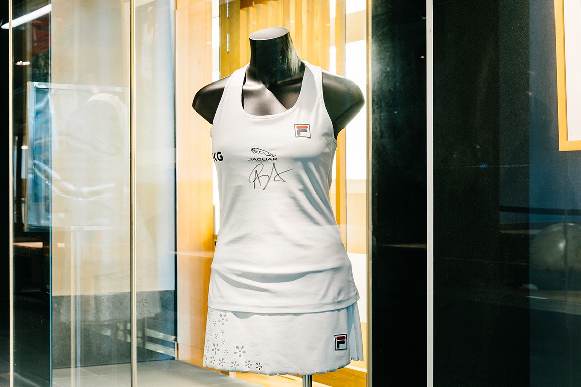 White scallop-hemmed skort and top made for Australian tennis champion Ash Barty to wear during her 2021 Wimbledon campaign The small daisy shaped flowers on the skort were laser cut from the fabric  Ash Barty has signed her initials on the centre front of the top