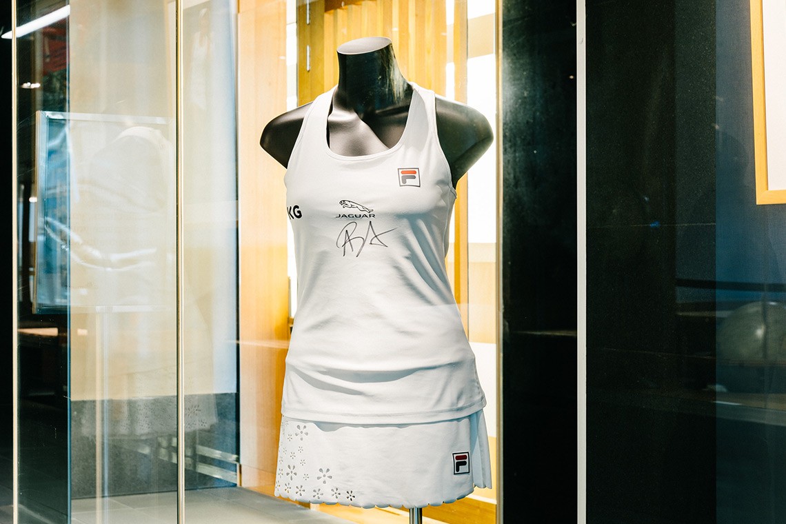 White, scallop-hemmed skort and top made for Australian tennis champion Ash Barty to wear during her 2021 Wimbledon campaign. The small daisy shaped flowers on the skort were laser cut from the fabric. Ash Barty has signed her initials on the centre front of the top.