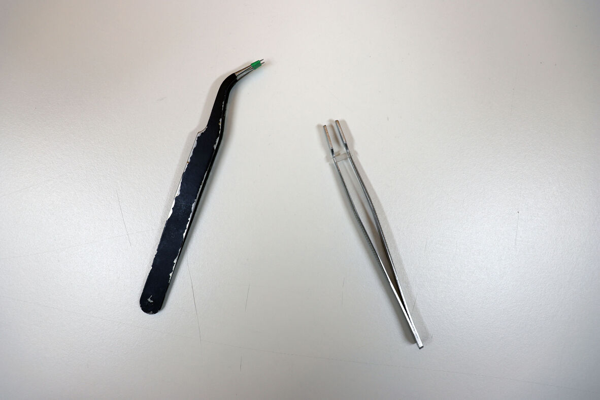 a overhead photo of two tweezers. 