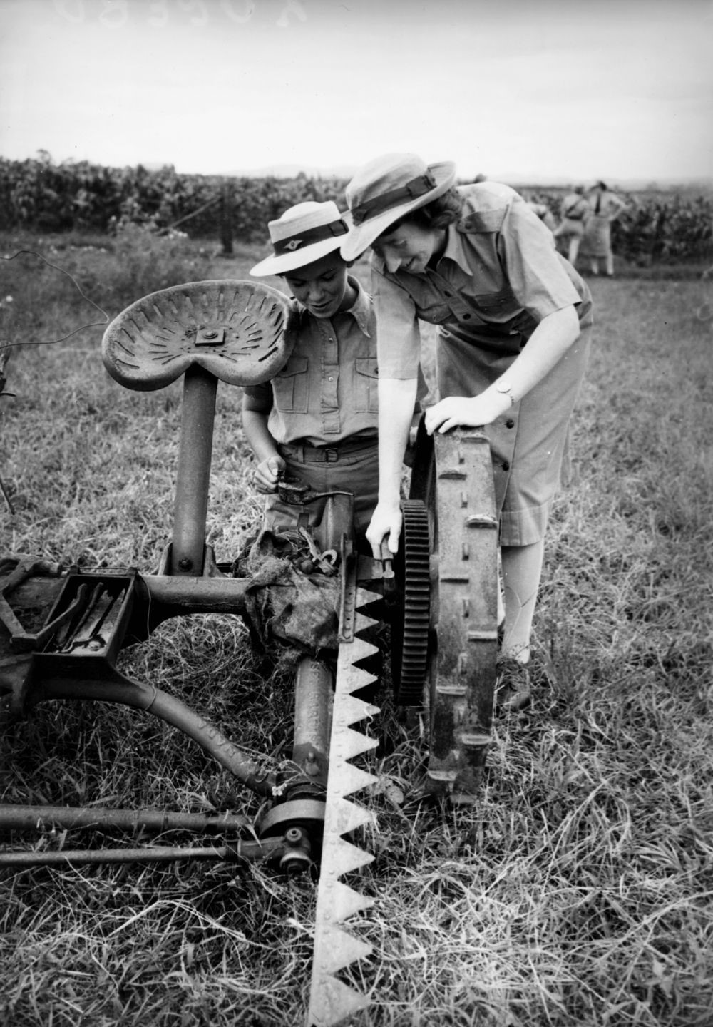 Two women working with farm machinary