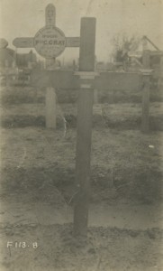 One wooden cross infront two wooden crosses behind military cemetery ca1917