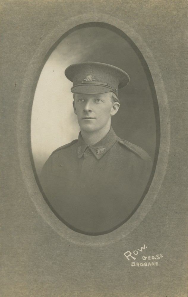 Black and white studio portrait of man in uniform ca1916