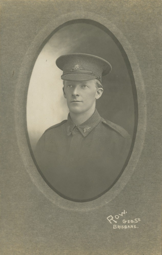 Black and white studio portrait of man in uniform, ca.1916